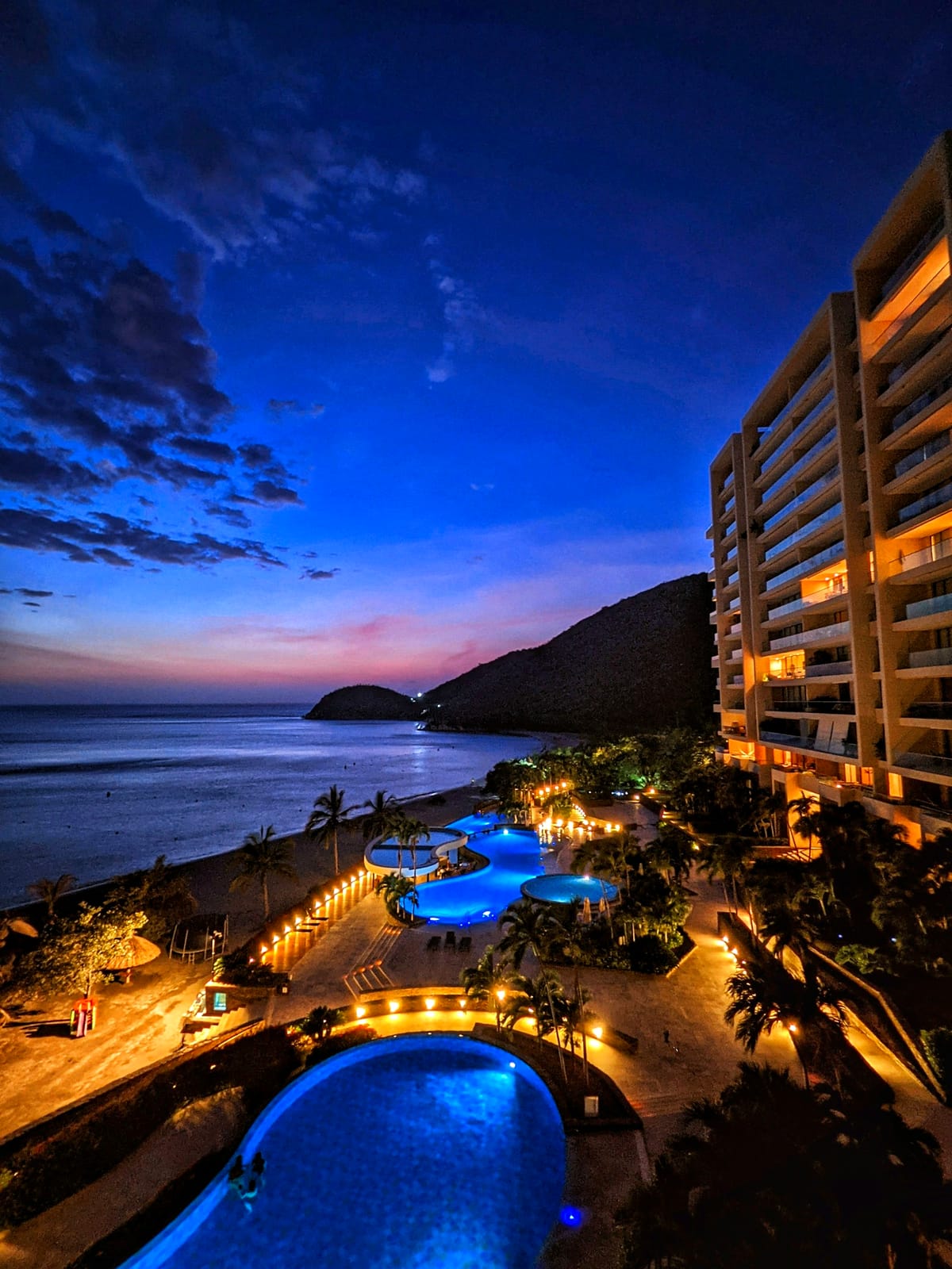 Beachfront resort pools at dusk in Mexico