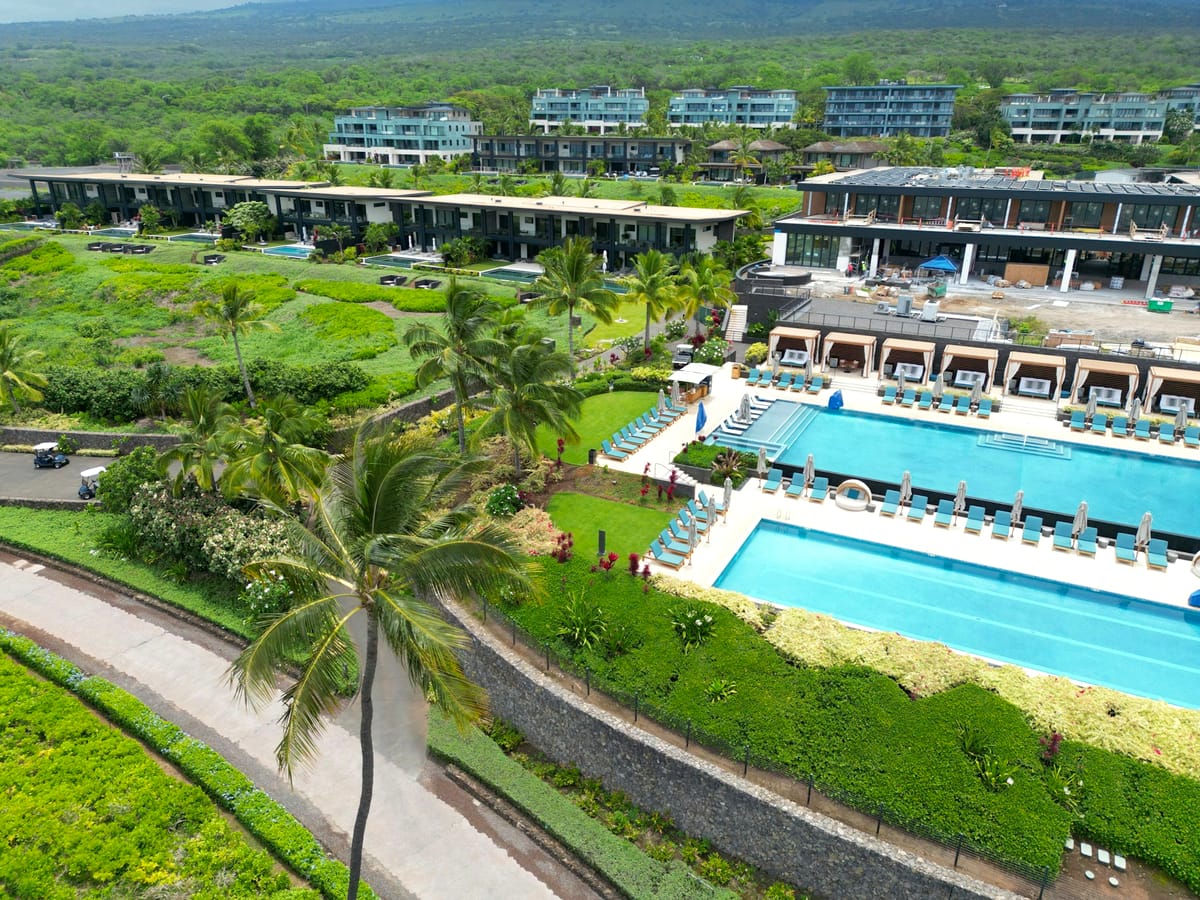 Oceanfront condo resort with pools and palm trees